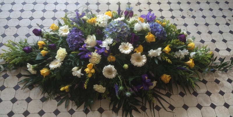 Casket spray in lemons blues and whites