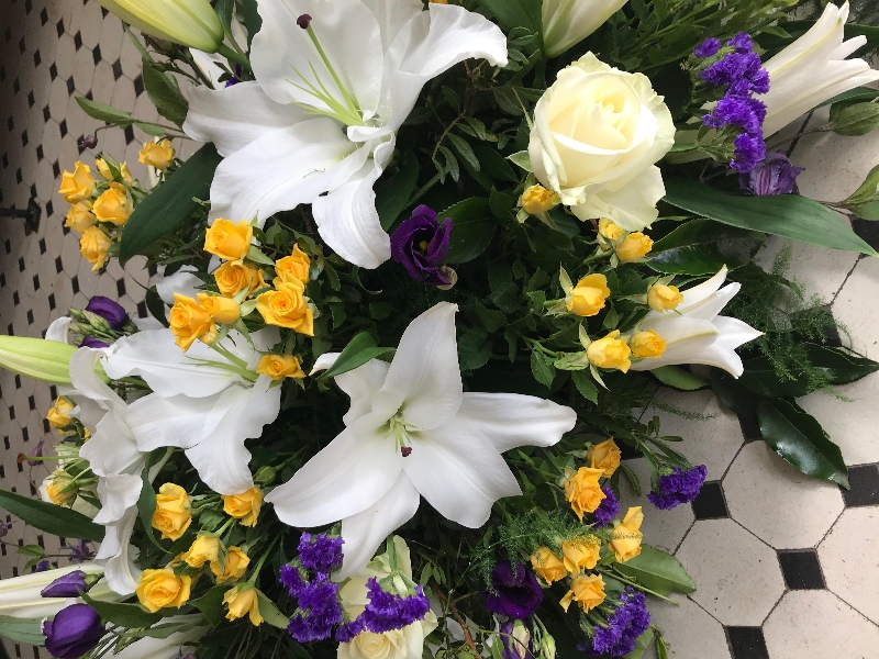 Lily and rose casket spray white purple and yellow