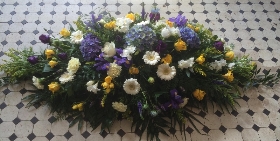 Casket spray in lemons blues and whites