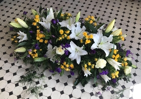 Lily and rose casket spray white purple and yellow